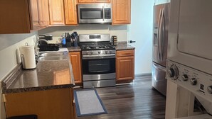 A kitchen with wooden cabinets, stainless steel appliances, and a built-in oven.
