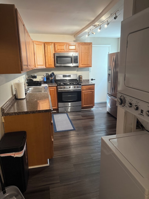 A kitchen with wooden cabinets, stainless steel appliances, and a built-in oven.