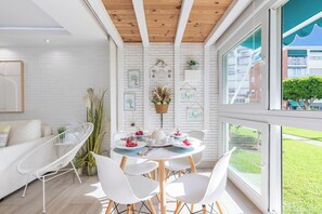 A modern interior with a dining area, white furniture, and a view of the outside. - Luxury White Summer Benalmadena (Benalmadena)