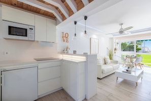 A modern kitchen with white cabinetry, a built-in microwave, and pendant lights. - Luxury White Summer Benalmadena (Benalmadena)