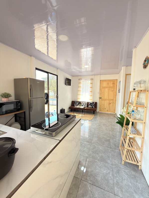 A modern kitchen with a built-in stove, a refrigerator, and a microwave.