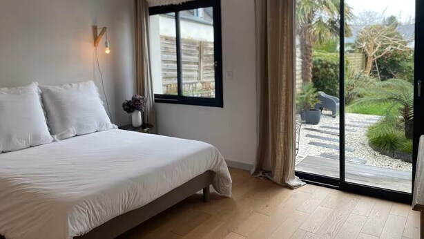 Une chambre à coucher avec un lit, une fenêtre et une vue sur l’extérieur.