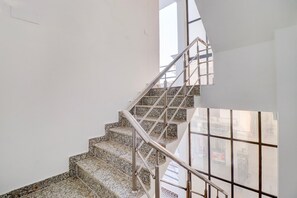A staircase with metal railings and granite steps. - Deluxe Benison Guest House (Dehradun)