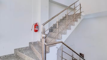 A staircase with metal railings and granite steps.