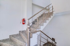 A staircase with metal railings and granite steps. - Deluxe Benison Guest House (Dehradun)