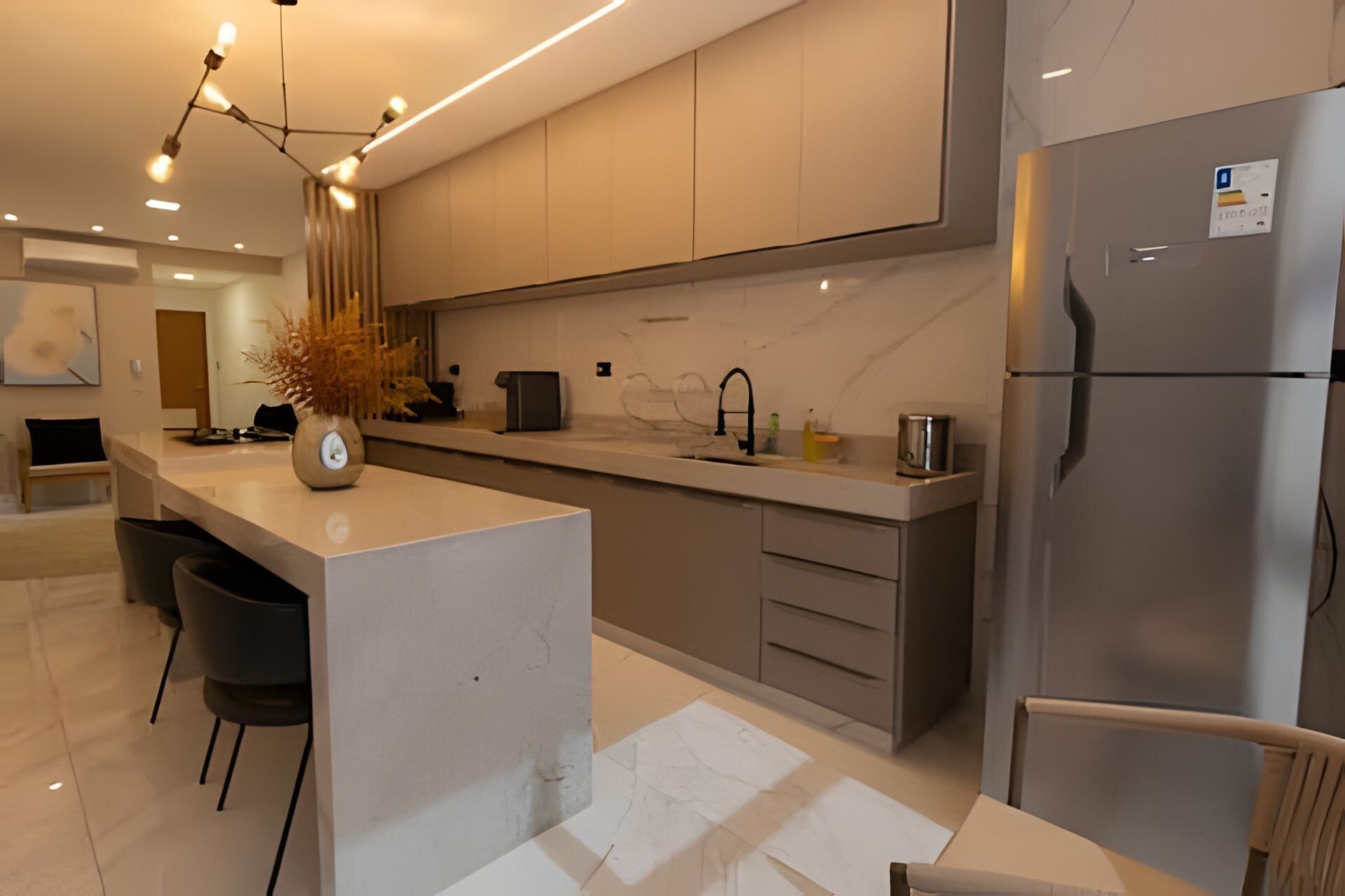 A modern kitchen with a central island, stainless steel appliances, and a minimalist design.