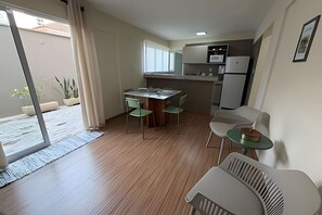 A compact kitchen with a dining area, a small table, and chairs.
