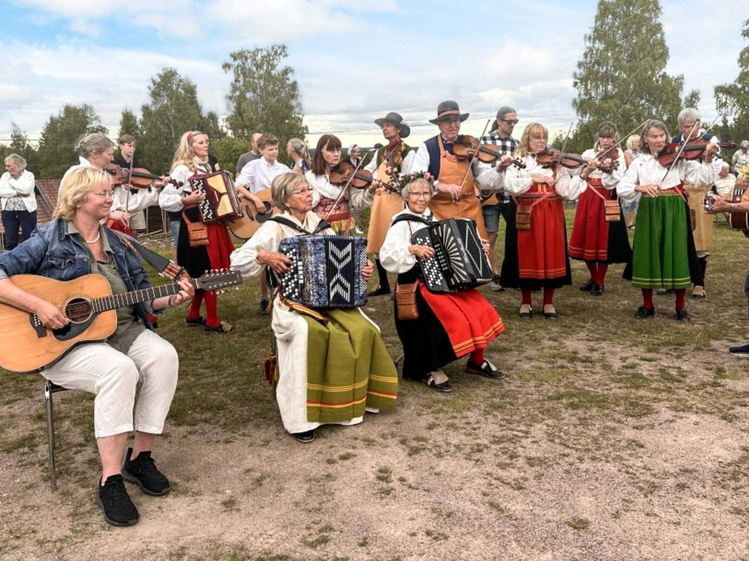 A group of people in traditional attire playing musical instruments.