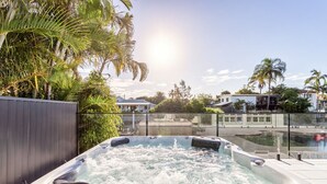 A hot tub with a view of a residential area and palm trees. - Coastal Waterfront Broadbeach Waters (Broadbeach Waters)