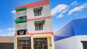 A hotel with a modern facade, a visible entrance, and a sign indicating it is a hotel. - Deluxe Tyagi Road Dehradun Railway Station (Dehradun)