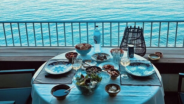 A table set for dining with a view of the sea. - Exceptional appartement with Sea view and beach private access (San Martino Di Lota)