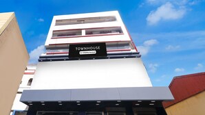 A modern building with a 'TOWNHOUSE' sign, indicating a company-serviced property. - Super Deluxe Room Bank More Dhanbad (Dhanbad)