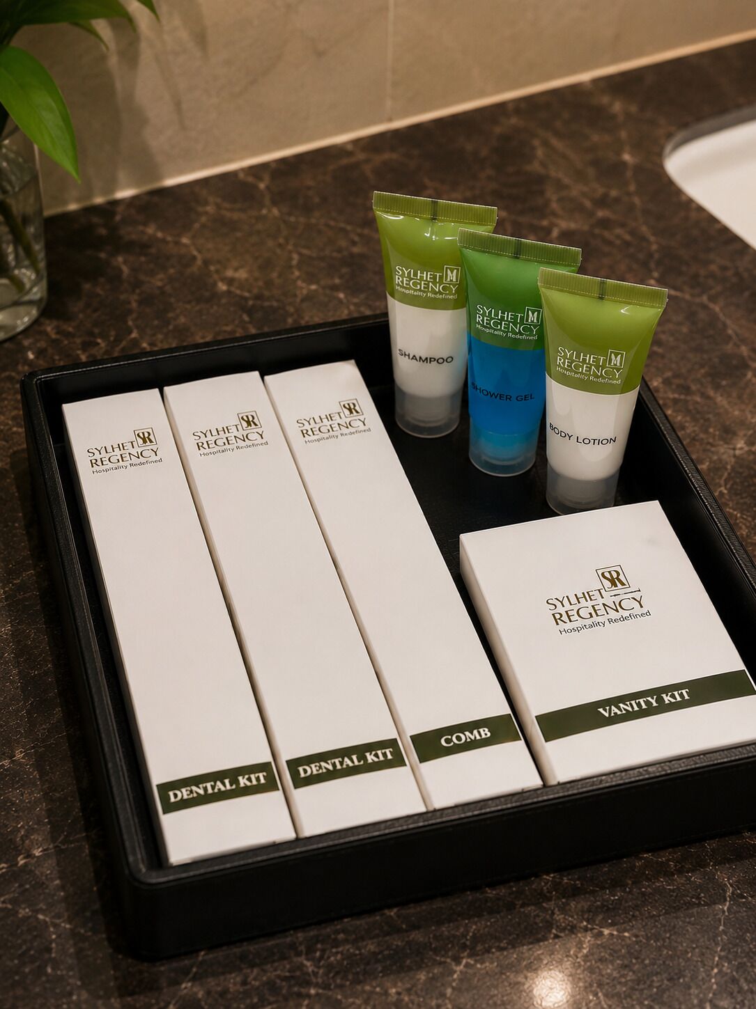A tray with toiletries including shampoo, shower gel, body lotion, and a vanity kit.