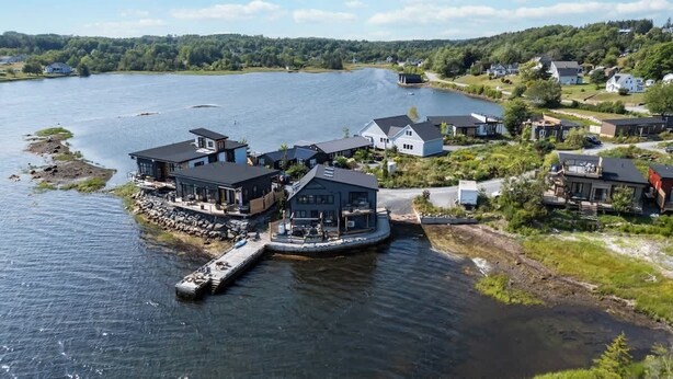 A lakeside property with multiple houses, a dock, and a pier. - A Little piece of Paradise - stunning ocean views! (Lunenburg)