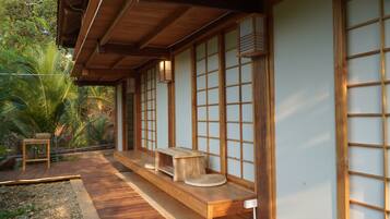 A traditional Japanese-style building with wooden beams, tatami flooring, and sliding doors.