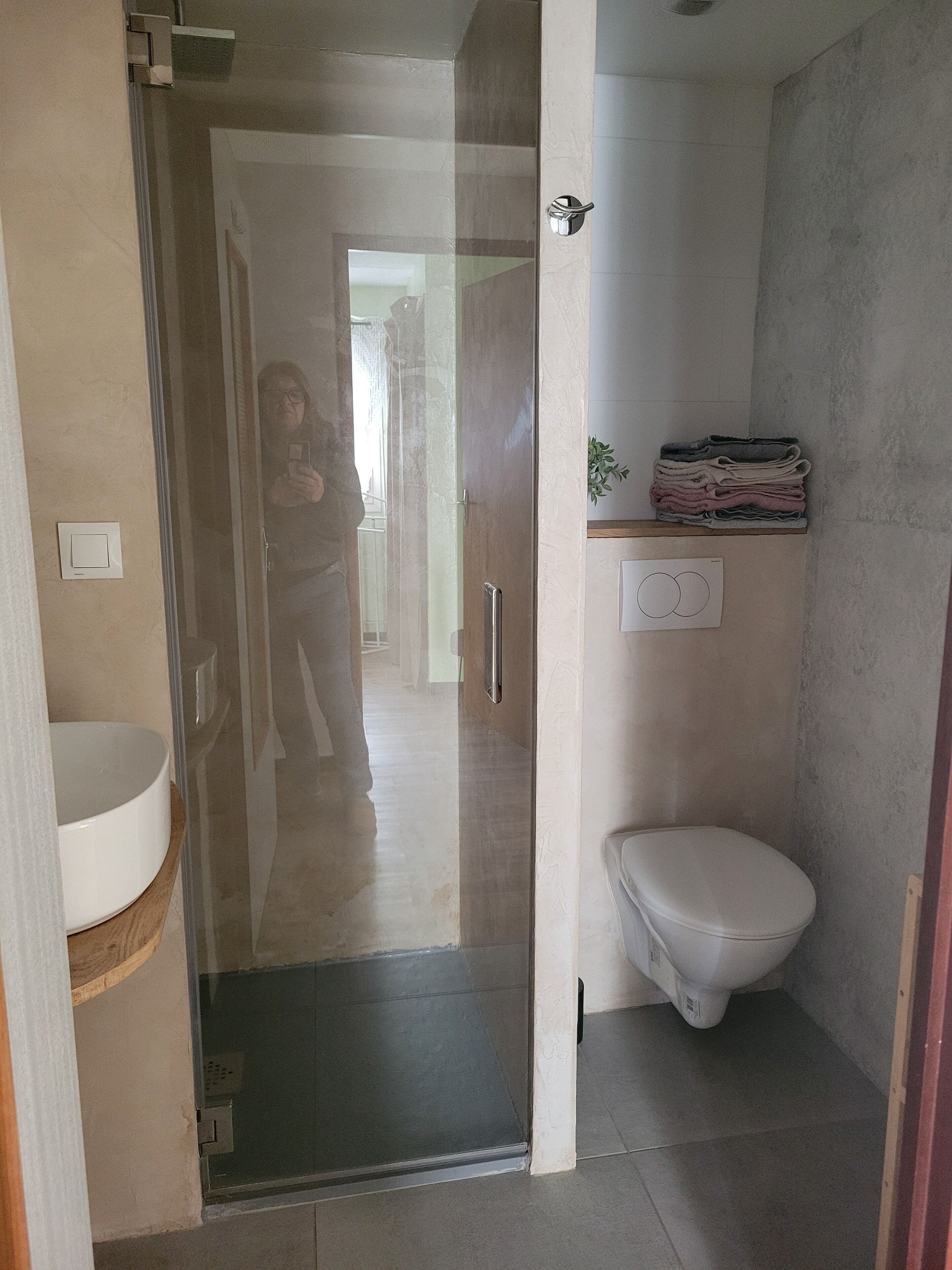 Shower, hair dryer, towels, toilet paper