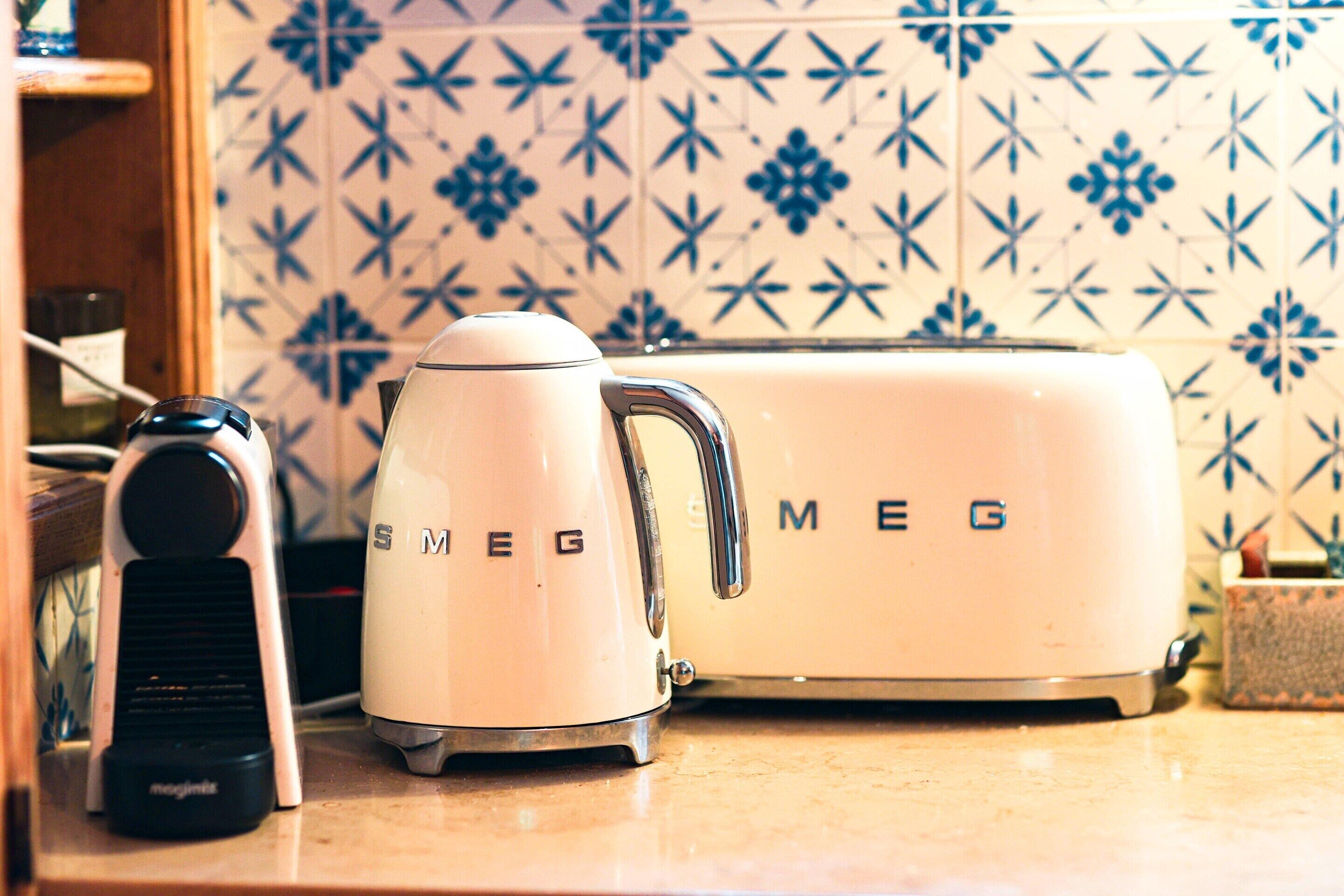 A kitchen with a toaster and a coffee maker on the counter.