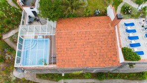 A rooftop pool with a tennis court, lounge chairs, and a garden area. - Ocean Heated Pool Jacuzzi View Executive202 (Santa Cruz)