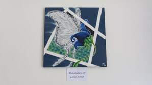 A framed artwork titled 'Exhibition of Local Artist' featuring a stylized bird with blue and green colors. - R&B Casa Wanda since 1999 (Riva del Garda)