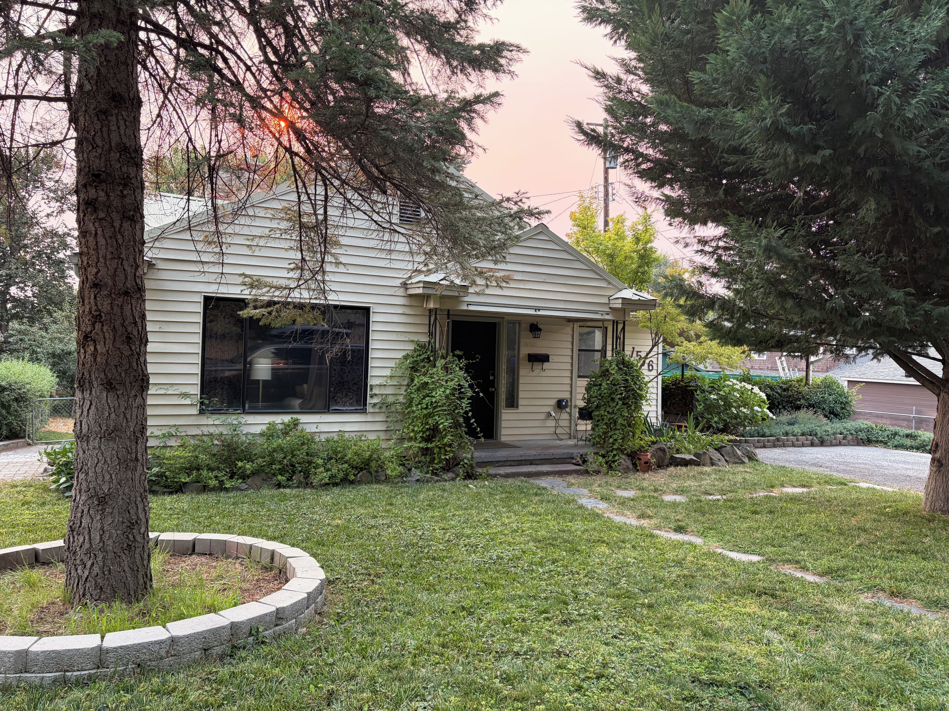 A single-story house with a front porch, a small front yard, and a mailbox.