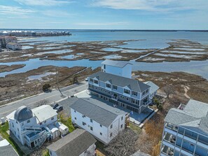 A coastal building complex with multiple structures, including a large two-story building with a flat roof and a smaller attached building with a dome. - Bayview Condo Short Walk to Beach (Ocean City)