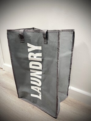 A grey laundry bag with the word 'LAUNDRY' on it. - Modern Studio With Free Parking Near City Airport and ExCel (London)