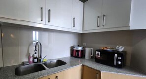 Kühlschrank, Mikrowelle, Herdplatte, Wasserkocher mit Kaffee-/Teezubehör