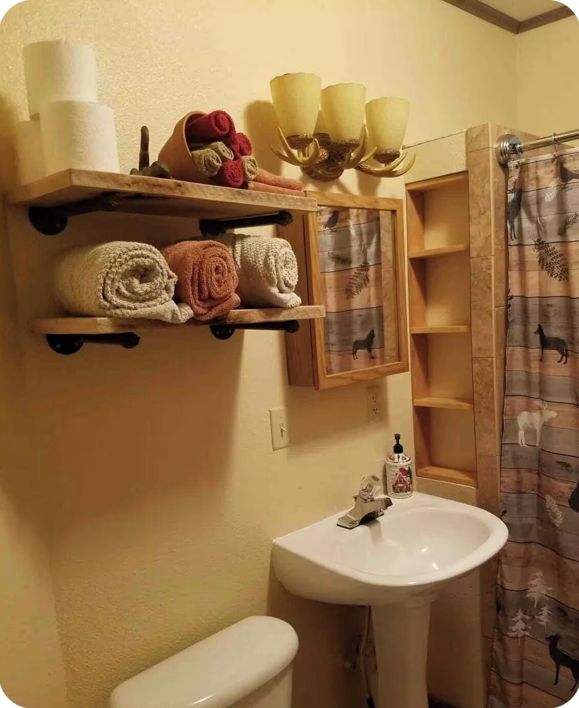 A bathroom with a toilet, sink, towel rack, and shower curtain.