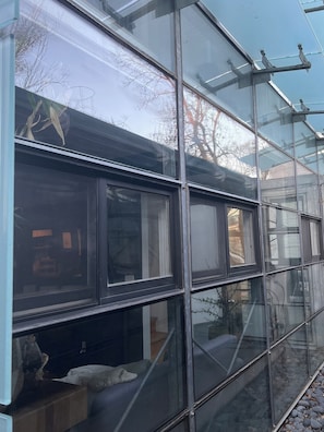 A modern building with large glass windows and metal frames. - World Cup HQ: Dan Rockhill-Designed Luxury Apt, Lawrence's Coolest Neighborhood (Lawrence)