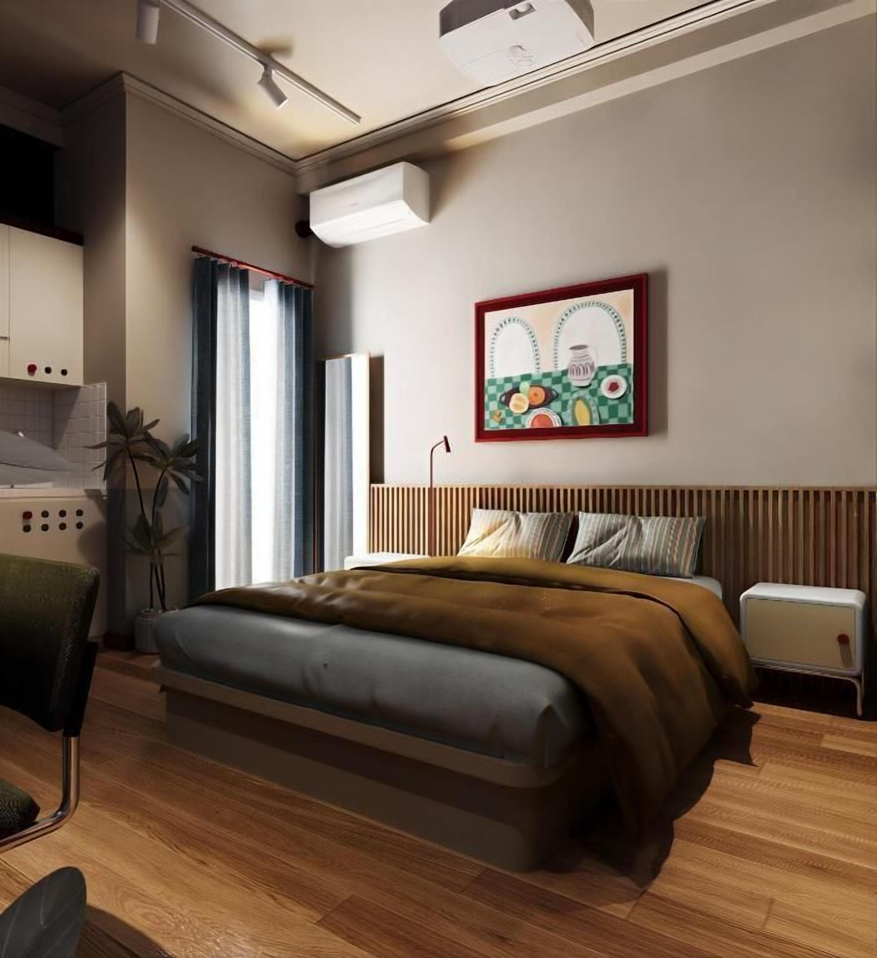 Un dormitorio moderno con cama, mesita de noche y aire acondicionado instalado en la pared.