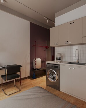 A modern kitchen with a washing machine, a coffee maker, and a red lamp. - The Rare Rooms by The Bloom - Saigon (Ho Chi Minh)