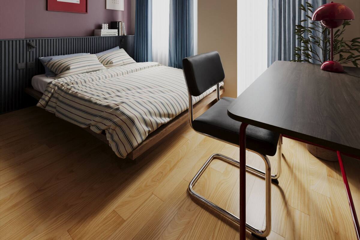 A modern hotel room with a bed, a desk, a chair, a radiator, a window with curtains, and an air conditioning unit.