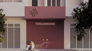 A building facade with a maroon door labeled 'THERAREROOMS' and a scooter parked in front. - The Rare Rooms by The Bloom - Saigon (Ho Chi Minh City)