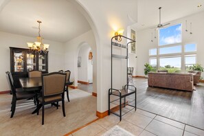 Bright open living & dining area with soaring ceilings and big windows