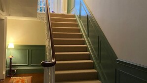 A staircase with a handrail, carpeted steps, and a green wall. - Ashville Georgian House -
Historic period property close to Strangford Lough (Newtownards)