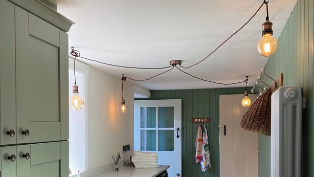 A kitchen with a washing machine, a bench, and hanging lights. - Ashville Georgian House -
Historic period property close to Strangford Lough (Newtownards)