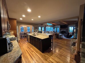 A spacious kitchen with a large island, wooden flooring, and built-in appliances. - MTN views - Sleeps 12 - Large Kitchen & Living Room - Game & Movie Room (Ellijay)