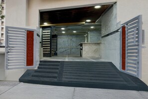 A set of stairs leading to a room with a marble wall and a counter. - Townhouse Financial District Circle (Hyderabad)