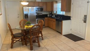 A compact kitchen with a dining table, chairs, a refrigerator, microwave, stove, dishwasher, and a small window. - Areas Best Value - Private - Near all attractions- Secure and Immaculately Clean (Nokomis)