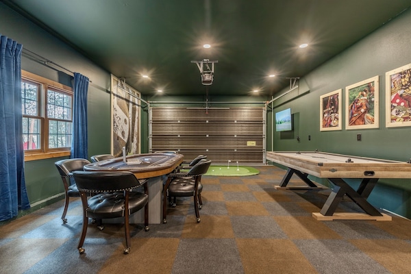 Check out this garage made game room. Equipped with air hockey, 6-person poker table, putting green, arcade games, dartboard, foose ball and two smart TVs.