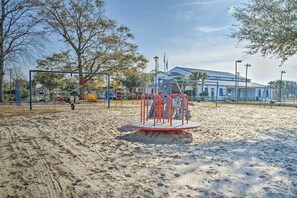 A playground with swings and a merry-go-round. - 3-bedroom Myrtle beach house just a short walk to beach. Includes golf cart. (Myrtle Beach)