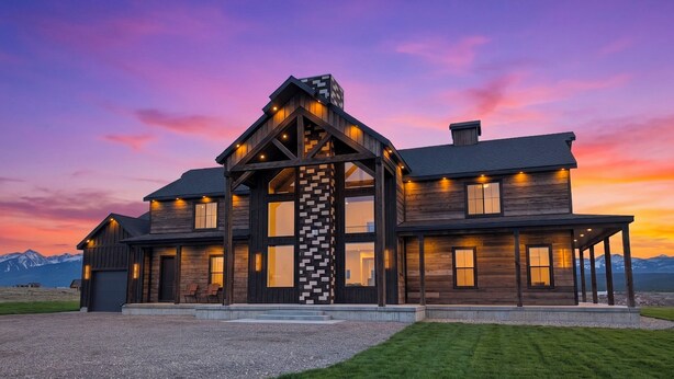 A large, modern house with a prominent central tower, multiple windows, and a well-maintained lawn. - Checkmate (Island Park)