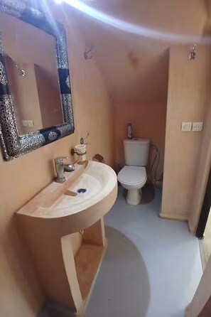 A compact bathroom with a sink, mirror, toilet, and a small shelf. - Villa Marine Privée (heated pool, 5 bedrooms) (Marrakech)