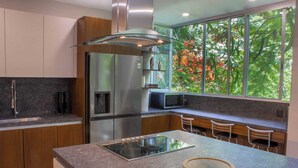 A modern kitchen with a built-in refrigerator, microwave, and stove. - Luxurious Villa in Amapas, Zona Romantica, Malecon! (Puerto Vallarta)