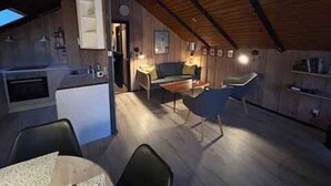 A cozy loft-style room with a kitchen, dining area, and seating space. - 4 Star Holiday Home in Fjerritslev (Fjerritslev)