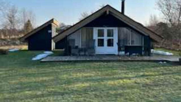A single-story house with a gabled roof, a front door, and a chimney. - 4 Star Holiday Home in Fjerritslev (Fjerritslev)