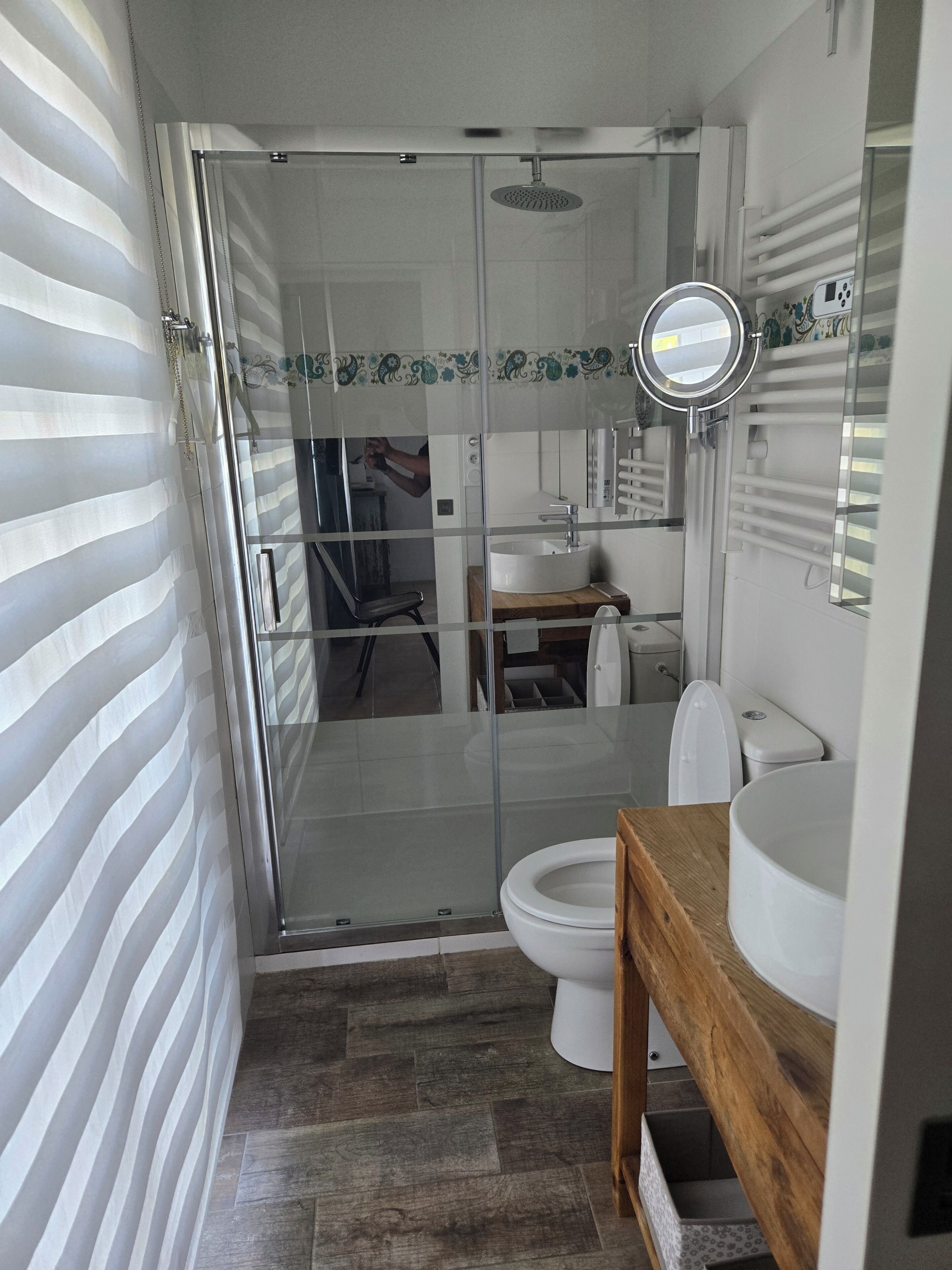 A bathroom with a shower, toilet, and sink.
