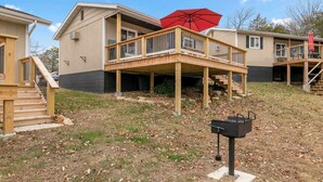 A two-story house with a deck, a red umbrella, and a barbecue grill. - Crest View Cabin - Lakefront Table Rock Lake (Galena)