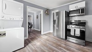 A modern kitchen with a stainless steel refrigerator, microwave, oven, and a built-in dishwasher. - Cozy Getaway Near Downtown Concord (Concord)