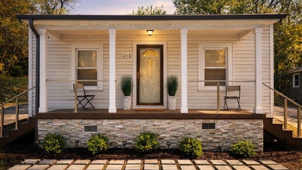 A single-story house with a stone foundation, a front porch with two chairs, and a door with a number '213' above it. - Cozy Getaway Near Downtown Concord (Concord)